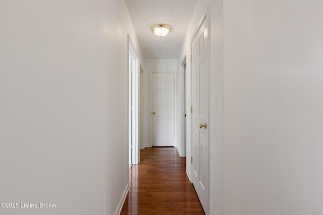 10436 Monticello Forest Cir, Louisville, KY 40299 - corridor with a textured ceiling, dark wood-style floors, and baseboards