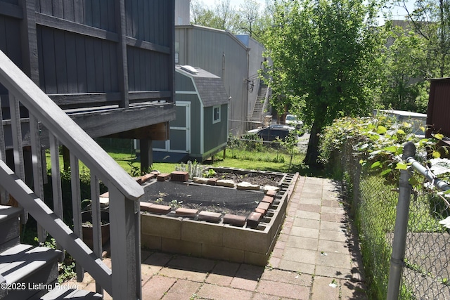 view of patio / terrace with fence and an outbuilding