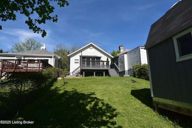 back of house featuring stairs, a wooden deck, and a yard
