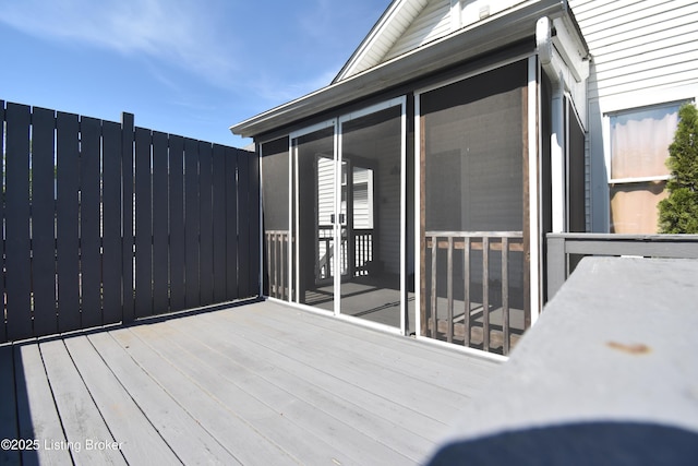 wooden deck featuring a sunroom