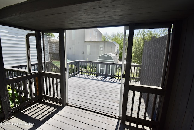 deck with a storage shed and an outdoor structure