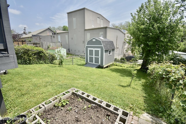 view of yard featuring an outdoor structure, a fenced backyard, a garden, and a shed