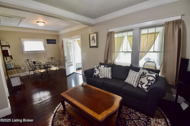 living room featuring crown molding, attic access, baseboards, and wood finished floors