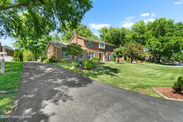 7103 Green Spring Dr, Louisville, KY 40241 - view of front of house with brick siding, a chimney, and a front yard