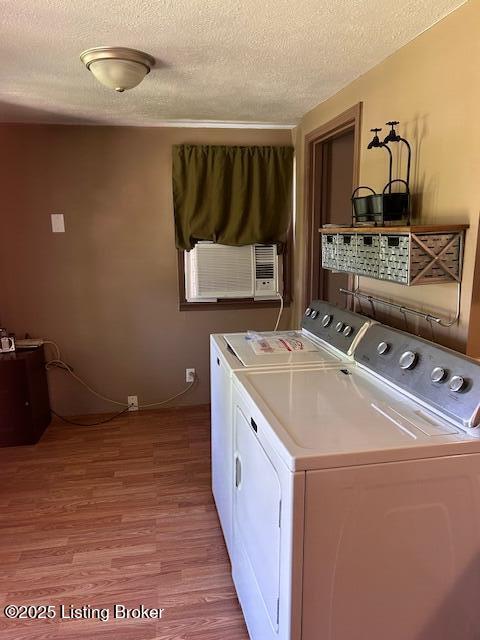 89 Peach St, New Haven, KY 40051 - clothes washing area with cooling unit, laundry area, light wood-style floors, washing machine and dryer, and a textured ceiling