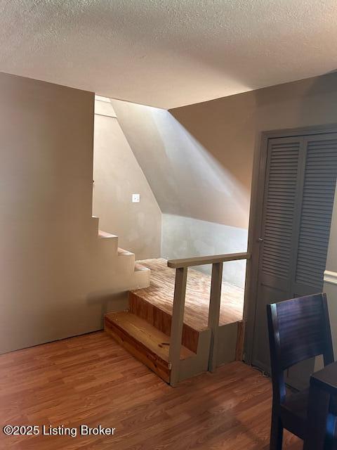 89 Peach St, New Haven, KY 40051 - staircase featuring a textured ceiling and wood finished floors