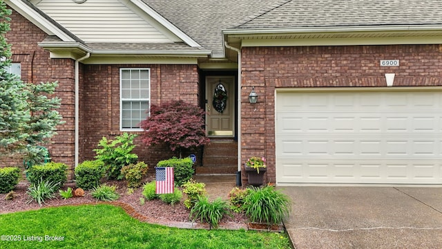 property entrance with a shingled roof, brick siding, and an attached garage