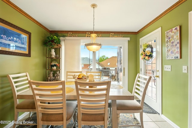 dining space with crown molding, baseboards, and light tile patterned flooring