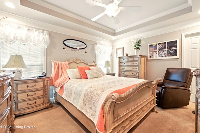 bedroom with light carpet, a raised ceiling, crown molding, and a ceiling fan