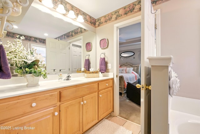 bathroom with connected bathroom, tile patterned floors, and vanity