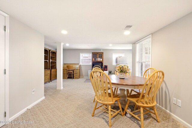 dining space featuring baseboards, recessed lighting, light carpet, and decorative columns