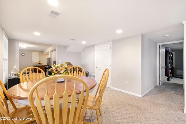 dining area featuring baseboards, light carpet, and recessed lighting
