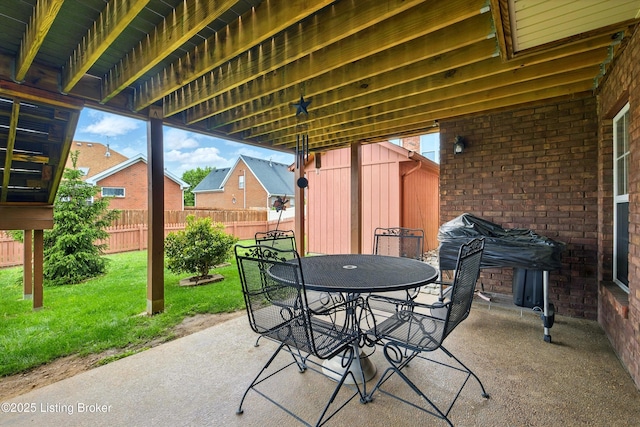 view of patio / terrace with outdoor dining area, a storage shed, and an outdoor structure