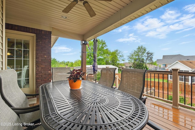 deck featuring outdoor dining area and ceiling fan