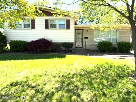 split level home featuring a front lawn