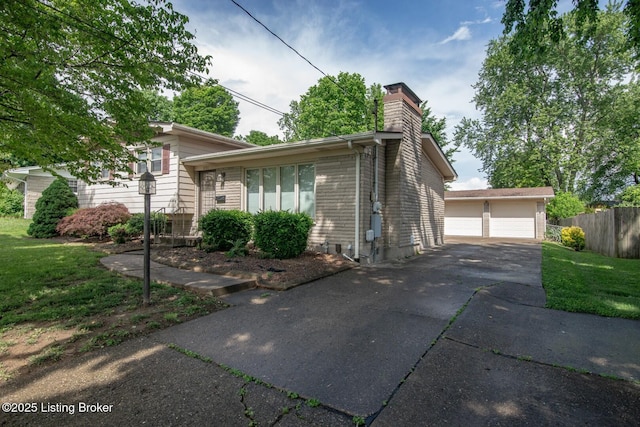 8701 Cottingham Way, Louisville, KY 40258 - view of property exterior with a chimney, a detached garage, an outbuilding, and brick siding