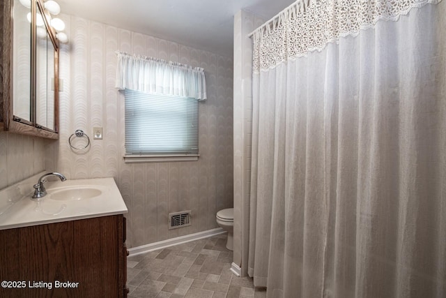 8701 Cottingham Way, Louisville, KY 40258 - full bathroom featuring wallpapered walls, toilet, baseboards, and vanity