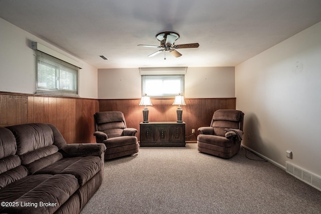 8701 Cottingham Way, Louisville, KY 40258 - carpeted living room featuring wainscoting, wooden walls, and a ceiling fan