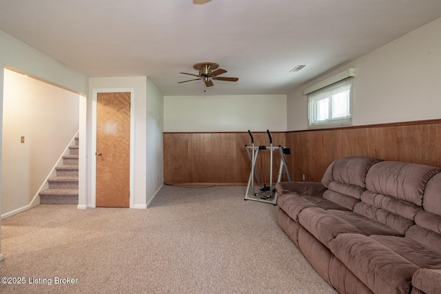 8701 Cottingham Way, Louisville, KY 40258 - living area featuring wainscoting, carpet, ceiling fan, stairway, and wooden walls