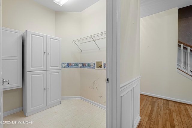8507 Missionary Ct, Louisville, KY 40291 - washroom featuring baseboards, washer hookup, and light wood-style floors