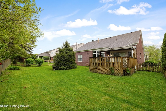 8507 Missionary Ct, Louisville, KY 40291 - rear view of house with a lawn, a shingled roof, a wooden deck, and a fenced backyard