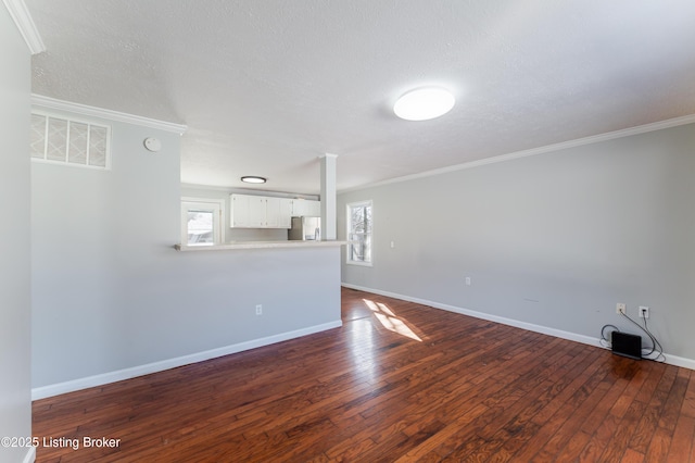 unfurnished living room featuring a textured ceiling, visible vents, baseboards, ornamental molding, and dark wood-type flooring