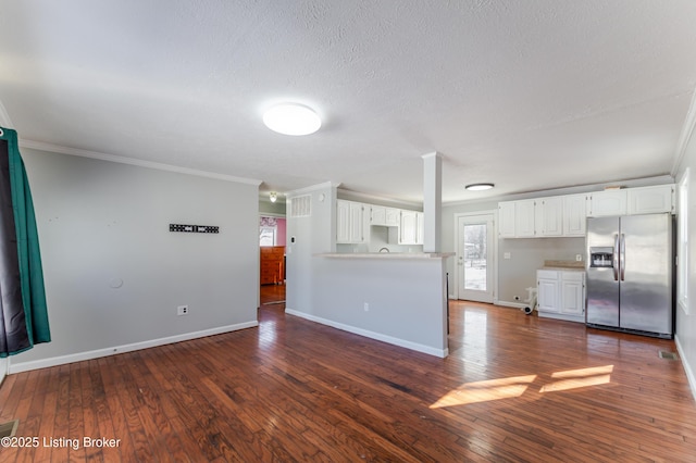 unfurnished living room featuring crown molding, baseboards, dark wood-style floors, and a healthy amount of sunlight