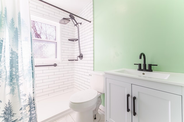 full bathroom featuring vanity, a shower stall, and toilet