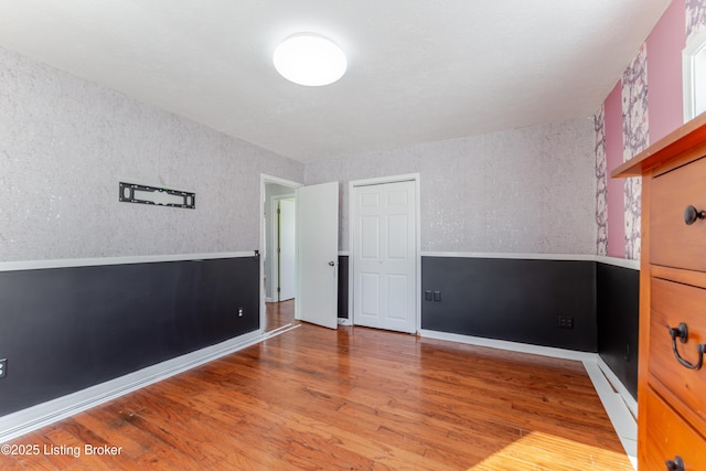 spare room with wood finished floors