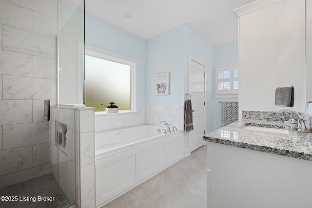 full bathroom featuring a bath, vanity, marble finish floor, and a stall shower