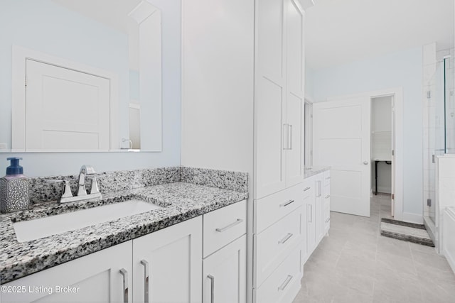 full bathroom with vanity, a shower with door, tile patterned floors, and a closet