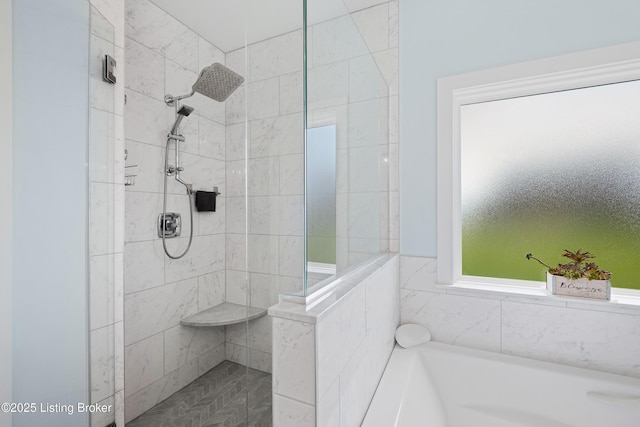 bathroom featuring a bath and tiled shower