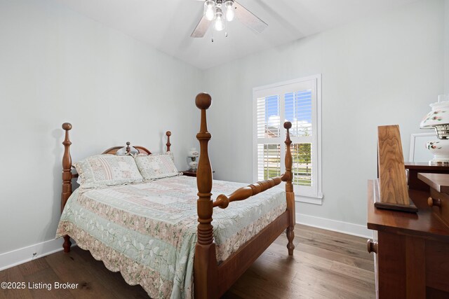 bedroom featuring baseboards and wood finished floors