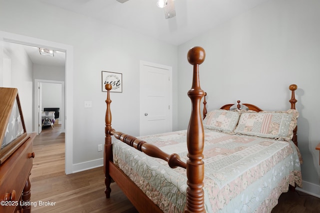 bedroom with baseboards, a ceiling fan, and wood finished floors