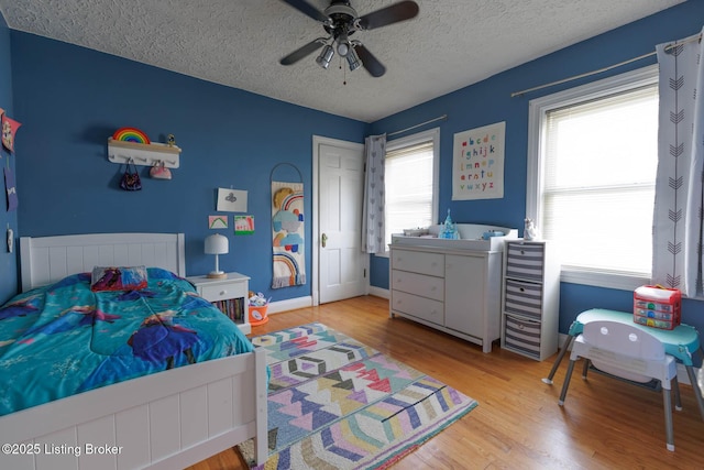 602 Merwin Ave, Louisville, KY 40217 - bedroom featuring a textured ceiling, ceiling fan, baseboards, and wood finished floors