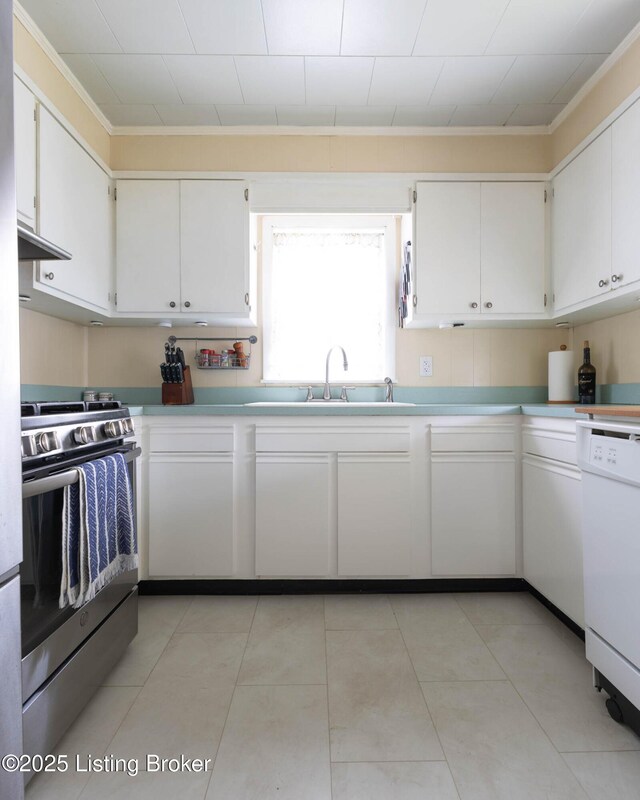 602 Merwin Ave, Louisville, KY 40217 - kitchen with crown molding, white dishwasher, stainless steel gas range, light countertops, and white cabinets