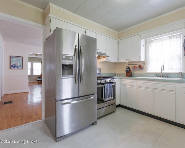 602 Merwin Ave, Louisville, KY 40217 - kitchen featuring visible vents, ornamental molding, light countertops, a sink, and appliances with stainless steel finishes
