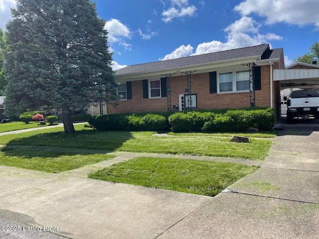view of front of home with a front yard, brick siding, concrete driveway, and an attached garage