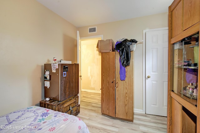 bedroom featuring visible vents and light wood finished floors