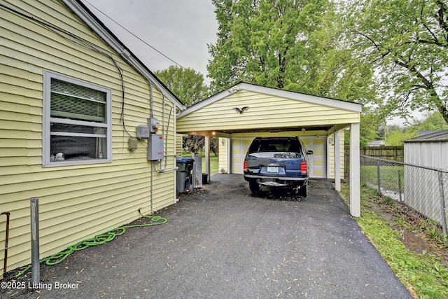 garage with fence and driveway