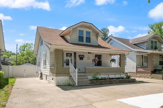 bungalow-style house featuring a gate, roof with shingles, and covered porch