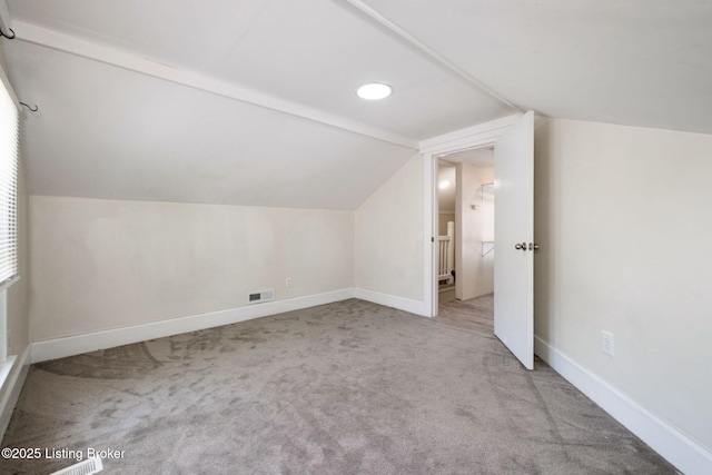 bonus room featuring carpet floors, baseboards, and lofted ceiling