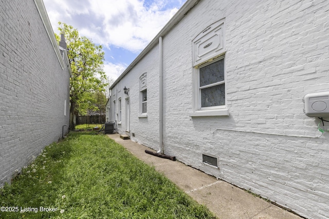 view of side of property featuring fence and crawl space