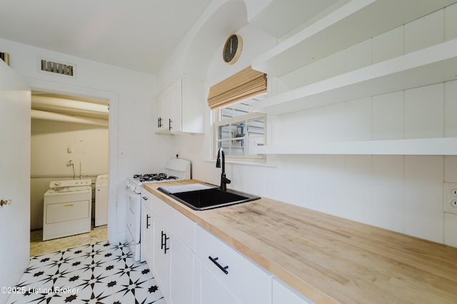kitchen with wooden counters, a sink, white range with gas cooktop, white cabinetry, and visible vents