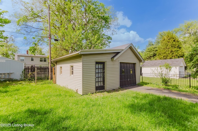 view of outdoor structure with an outbuilding and fence