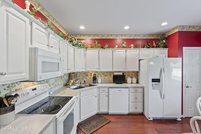 kitchen featuring dark wood-style flooring, white appliances, light countertops, white cabinetry, and a sink