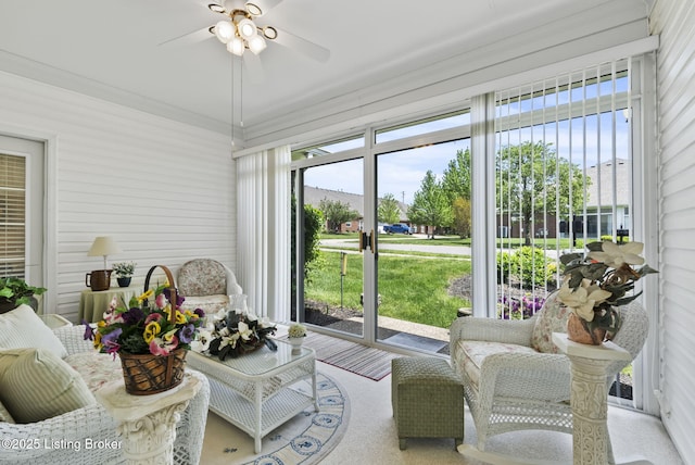 sunroom featuring a ceiling fan