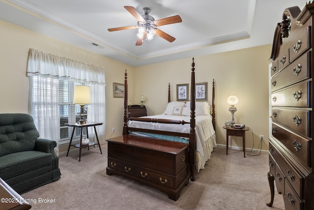 bedroom featuring light colored carpet, a raised ceiling, crown molding, and visible vents