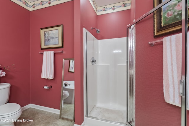 full bath featuring baseboards, tile patterned floors, a stall shower, and toilet