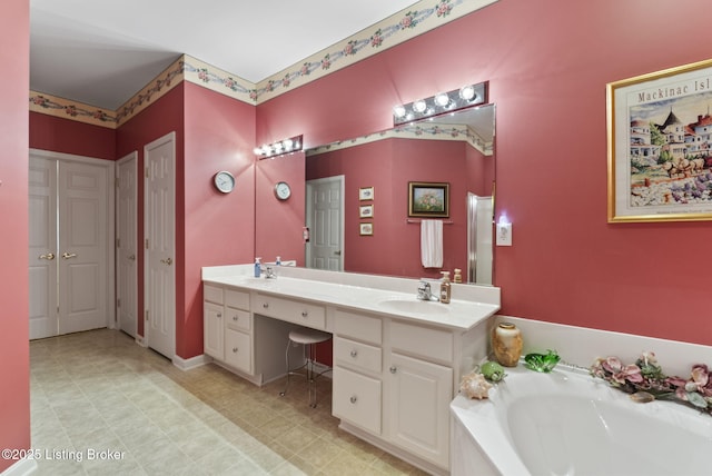 full bath with a sink, a bath, and double vanity